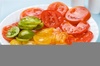 Plate of colorful fresh, juicy sliced Heirloom Tomatoes