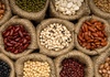 Large variety of dried beans in burlap containers