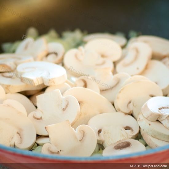 sliced white button mushrooms in a pan