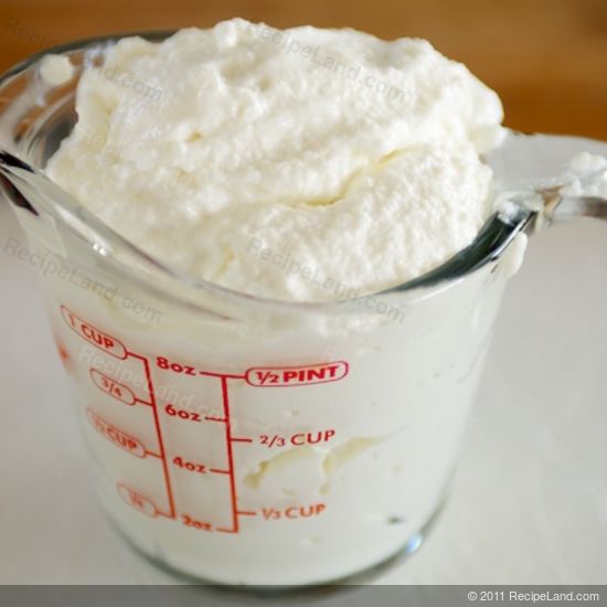 measuring cup full of ricotta cheese
