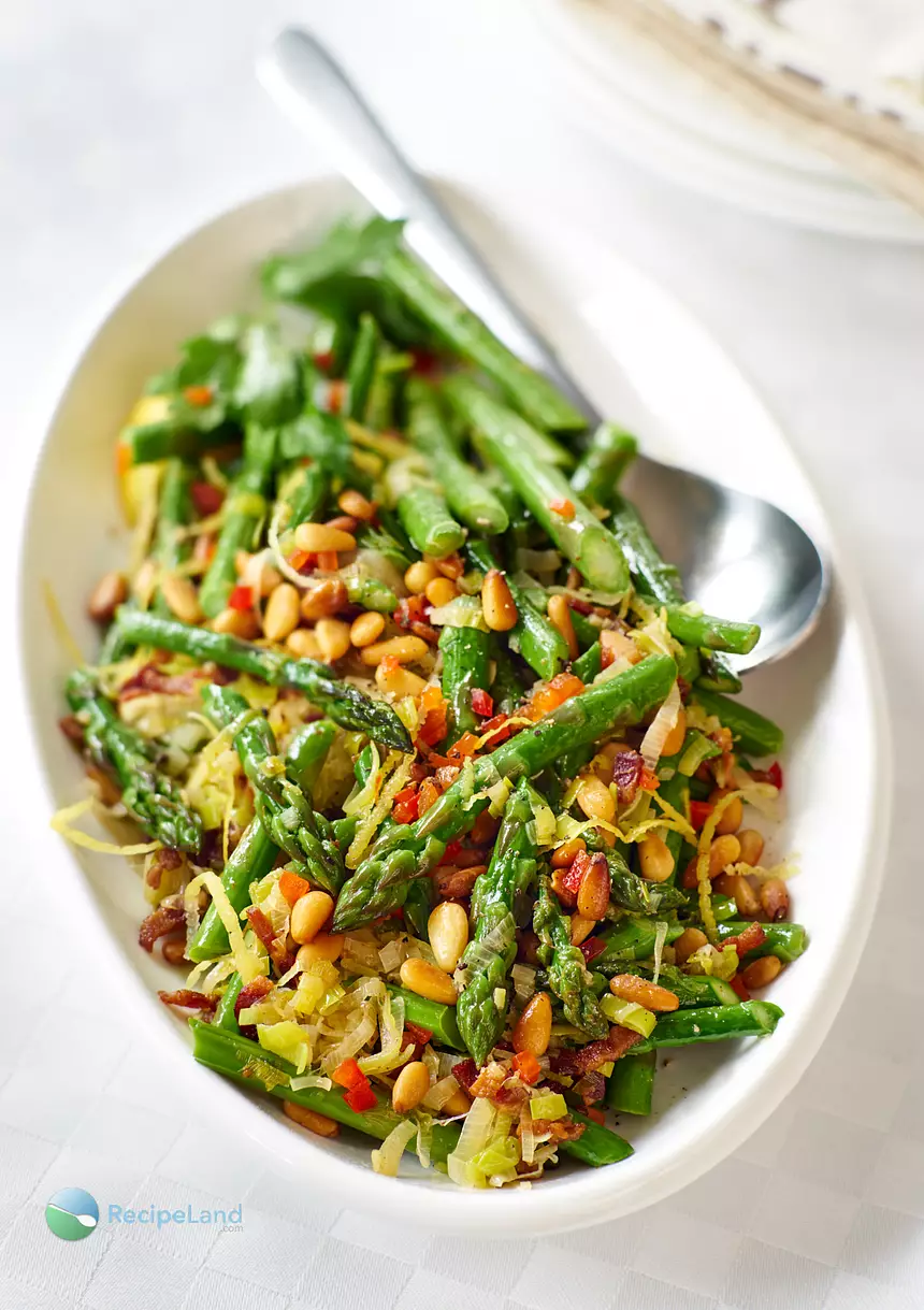 Sautèing asparagus with bacon (pancetta) and leeks is a perfect way to cook asparagus and keep it perfectly tender-crisp and finished with pine nuts and aromatic garlic, lemon and orange zest makes this side a sophisticated, delicious variety of textures and flavors.