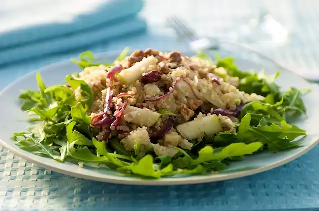 Quinoa and Arugula Salad with Pears, Walnuts, Dried Fruits, and Jack Cheese