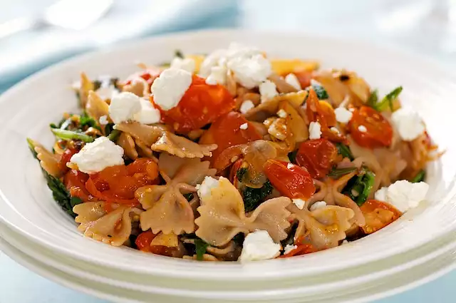 Warm Pasta with Roasted Tomatoes, Greens and Goat Cheese