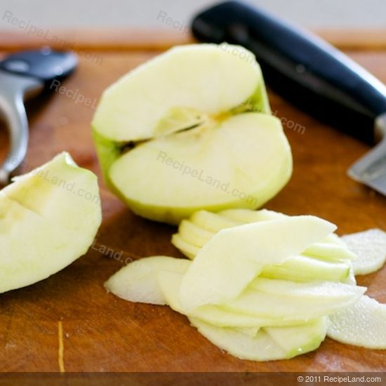 Sliced, halved and quartered Granny Smith apple