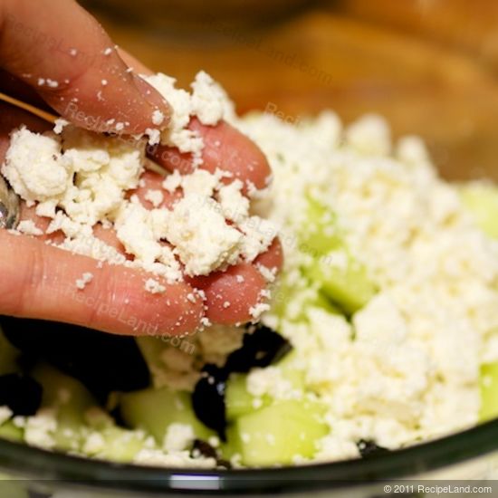 crumbled feta cheese in hand